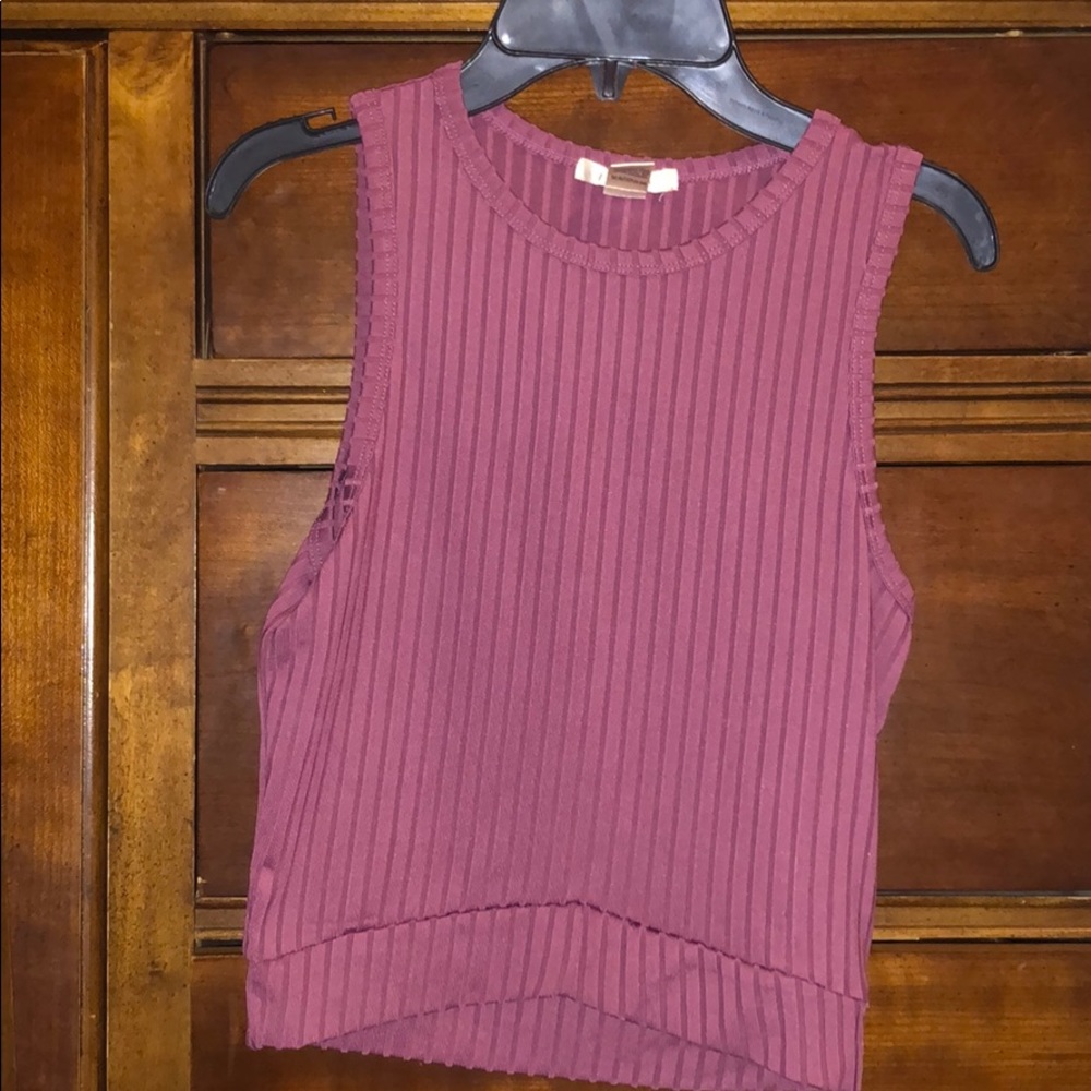 Sleeveless Tee and cropped in front.